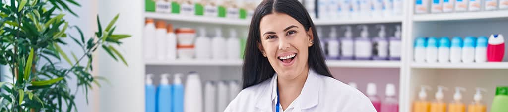 Female Pharmacist scanning bottles at pharmacy