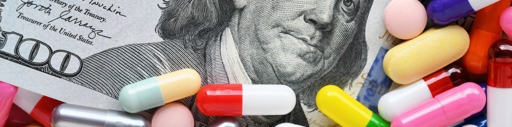 Pills on money dollars - Medicine prescription drugs cost concept - healthcare insurance expenses