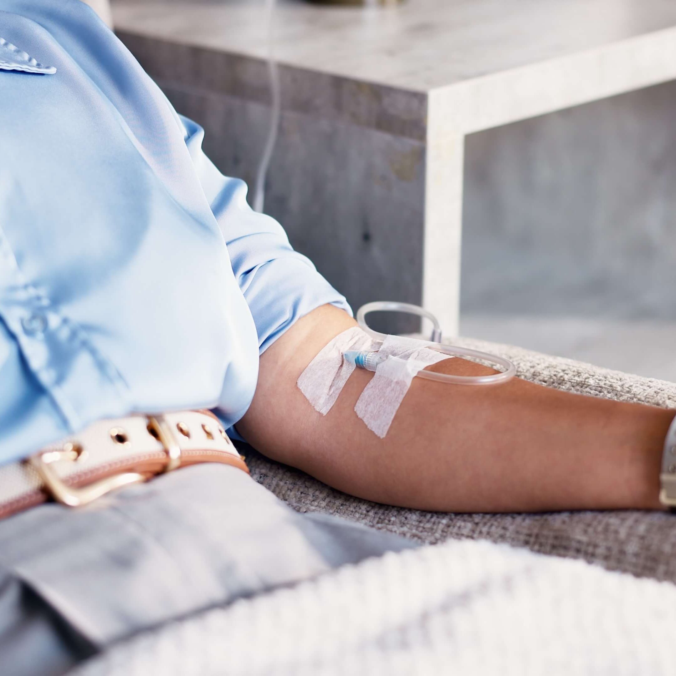 Patient resting with an IV line placed in their arm during an infusion therapy appointment.